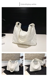 Detail of white star-quilted shoulder bag featuring premium texture and metal rings