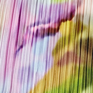 Macro shot of colorful plissé fabric with detailed pleats and watercolor print texture