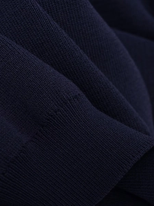 Detailed close-up showing the dense navy blue knit fabric texture and premium weaving patterns
