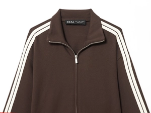 Detail of coffee brown zip-up sweatshirt showing high-quality fabric texture and collar