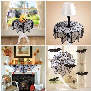 Detail of black lace spider web tablecloth and bat wall decals for Halloween party decor