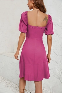 Close-up of fuchsia puff sleeve dress back with square neck and zipper detail