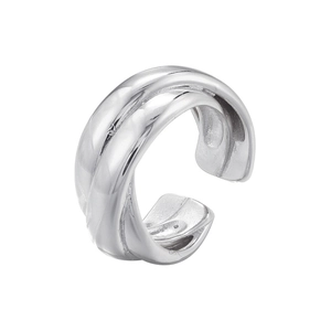 Macro view of silver ear cuff with double twist texture and polished metallic finish