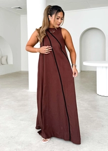 Detail of brown sleeveless maxi dress featuring elegant black diagonal stripe accents