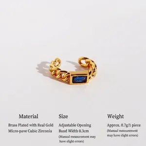 Gold chain ear cuff with a rectangular blue zircon stone and minimalist brass finish