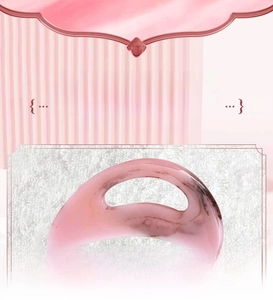 Macro detail of pink resin gua sha tool showing smooth hand-polished edges and texture