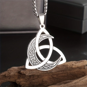 Detailed view of stainless steel Viking Valknut and Moon Phase pendant on rustic wood