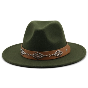 Detail of dark green fedora hat featuring a brown leather band with silver metal rivets