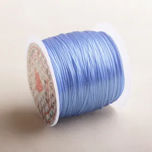 Macro detail of light blue elastic crystal string on a spool for DIY jewelry beading
