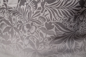 Macro shot of business casual polo shirt featuring intricate plant prints and textured fabric