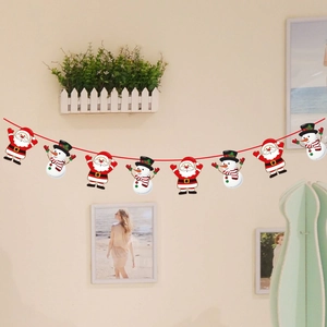 Detail of Christmas banner with cartoon Santa and snowman hanging on a red string