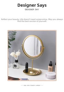 Detail of round gold iron vanity mirror with jewelry tray for earrings and cosmetics