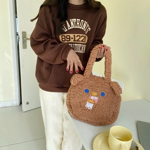 Detail of cute brown plush bear tote bag with milk tea embroidery and soft lamb wool texture