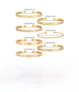Macro shot of 7-piece gold stainless steel bangles with diverse textured patterns