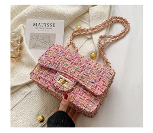 Pink tweed chain bag detail with gold clasp over a beige coat and artistic background