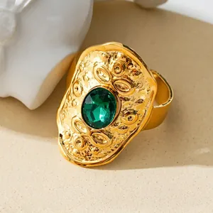 Bohemian style hammered gold ring with large oval green gemstone for a vintage look