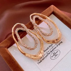 Gold plated oval double hoop earrings with sparkling rhinestones in a luxury jewelry box