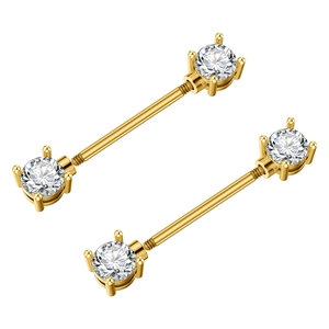 Macro detail of gold barbell nipple rings with white zircon in four-prong settings