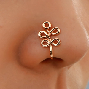 Macro shot of rose gold non-piercing U-shaped nose cuff with geometric wire wrapping