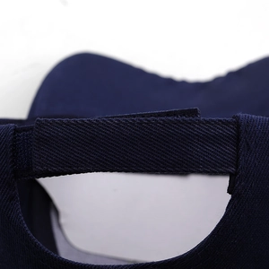Detail of adjustable strap on navy blue cotton baseball cap with premium stitching
