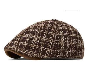 Detail view of coffee color tweed newsboy cap with classic woven texture and plaid pattern
