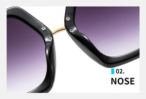 Detail des goldenen Metallstegs und der violetten Verlaufsgläser der großen Sonnenbrille