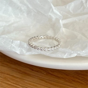 Elegant 925 sterling silver eternity ring with round cubic zirconia stones on white background