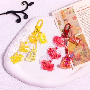 Detail view of colorful glitter acrylic candy bear keychains with sweet charms