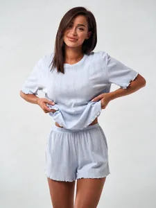Close-up of light blue loungewear set featuring pointelle knit fabric and ruffled edges