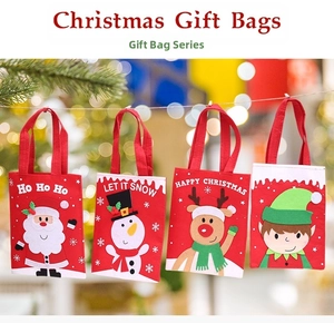 Detail of colorful Christmas felt gift bags with 3D cartoon characters and handles