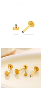 Macro detail of gold titanium labret stud showing hammered texture disk and internal thread