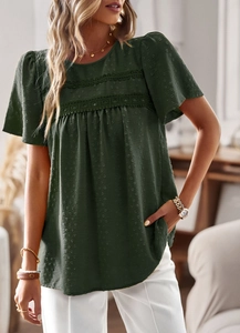 Detail of dark green textured blouse showing lace trim and tiered design on sleeve
