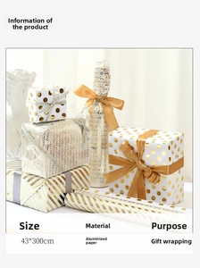 Detail of gold and white gift wrap with geometric patterns and golden ribbon accents