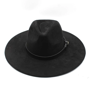 Detail of black suede fedora hat with a thin leather band and metallic buckle accent