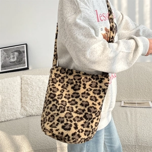 Chic leopard print faux fur bucket bag shown in a cozy home setting with a white sofa
