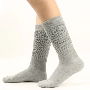 Detail of grey slouch socks showing textured wave knit pattern and thick ribbed fabric