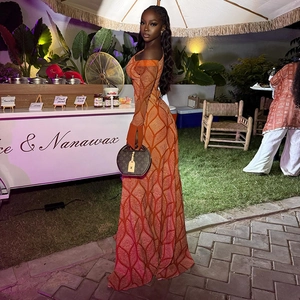 Detail of off-shoulder maxi dress with geometric diamond pattern and slim-fit long sleeves