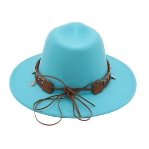 Detail of teal felt wide brim hat featuring ethnic embroidery and silver metal charms