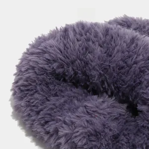 Macro shot of deep purple fuzzy faux fur texture on a creative winter knitted beanie