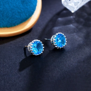 Macro shot of 8mm blue cubic zirconia crown stud earrings with silver metal base