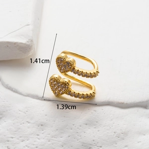 Macro view of gold heart ear cuff showing micro-inset zircons and 1.41cm size detail