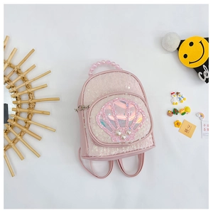 Detail of pink sequin shell backpack with pearl handle and cute decorative items