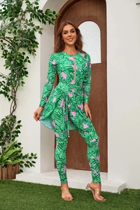 Detail of long-sleeve swimsuit with tropical leaf print and functional front zipper