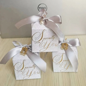 Elegant silver glitter wedding candy boxes with grey satin ribbons and golden charms