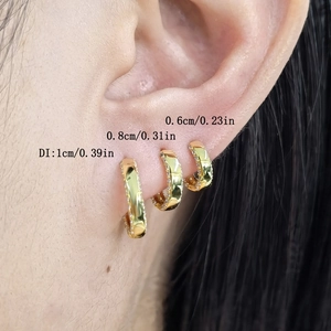 Three sizes of gold huggie earrings with micro-inlaid cubic zirconia on ear