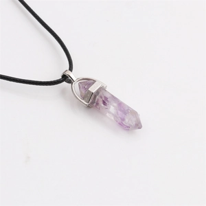 Macro shot of purple amethyst hexagonal pillar pendant on a black rope chain necklace