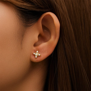 Close-up of S925 silver star stud earrings with opal stone and zircons on ear