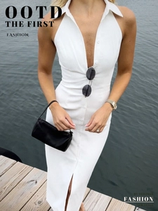 Detail of a white sleeveless button-up midi dress with a classic lapel and side slit
