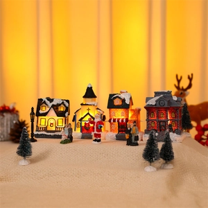 Detailed set of glowing resin Christmas village houses and Santa figurines for holiday decor