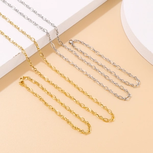Minimalist gold and silver O-link chains displayed on geometric blocks